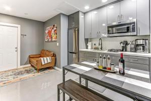 a kitchen with a table with wine bottles on it at Modern Rental - Pet-Friendly, Free Parking in Hollywood