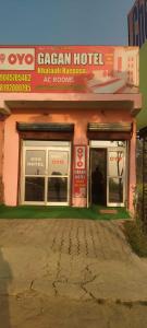 a store front of a pink building with windows at SPOT ON Gagan Hotel in Khatauli