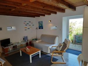 a living room with a couch and a table at Casinha Nº461 in Vila Praia de Âncora