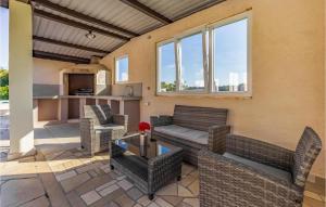 a patio with wicker chairs and a table at Awesome Home In Valtura With Wifi in Valtura