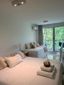 a bedroom with two beds with towels on them at Depto Oro - Palermo Nuevo in Buenos Aires