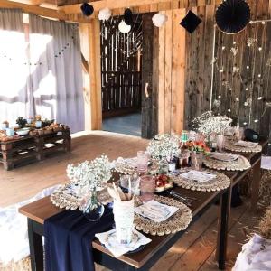 a table with plates of food and flowers on it at Zaczarowana Furmanka in Antolka