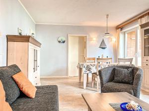 a living room with a couch and chairs and a table at Goosbrink Wohnung 13 in Boltenhagen