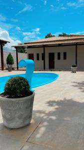 a house with a swimming pool in a yard at Pousada MKC in São Gonçalo do Amarante