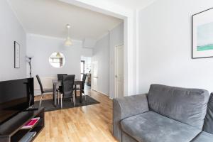 a living room with a couch and a table at Belfast City - 3 Bedroom Cosy Home - Walking Distance to City in Belfast