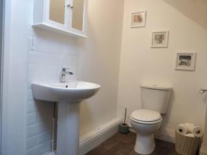 a bathroom with a sink and a toilet at The Rafters, Bank House, Stunning Apartment. in Millom