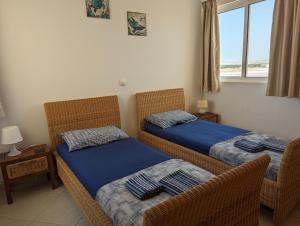two beds in a room with two chairs and a window at Vila Cabral 2 Apartments - AC in Sal Rei +231 photos