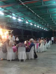a group of people sitting at tables in a room at Bonsai Homestay Kluang - Meranti in Kluang