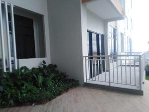 a balcony of a building with a gate and plants at Sakinah Homestay P5 Putrajaya in Putrajaya
