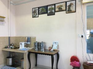a table in a kitchen with pictures on the wall at Bonsai Homestay Kluang - Meranti in Kluang