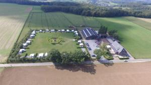 an aerial view of a farm with a large field at B&B Flamand in Heijenrath