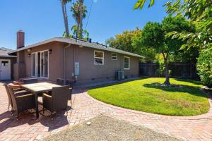 a patio with a table and chairs in front of a house at Great View & Bright 3Br home /AC/ San Jose in San Jose