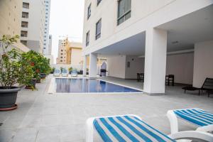 a swimming pool in the middle of a building at The Apple Residence in Juffair