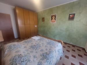 a small bedroom with a bed and a cabinet at AGLIANO LOVELY APARTMENT in Agliano Terme