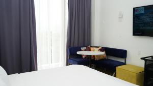 a room with a bed and a table and a chair at Aloft Ponce Hotel & Casino in Ponce