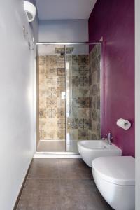 a bathroom with a shower and a toilet and a sink at Ziolì in Noto +40 photos