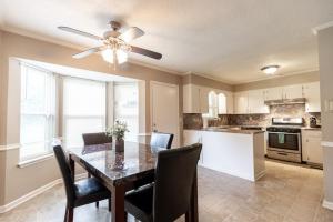a kitchen with a dining room table and a ceiling fan at Allwood Cottage 1 in North Little Rock