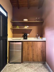 a kitchen with a counter and a sink and shelves at Cabin Retreat: Private Studio in Medellín