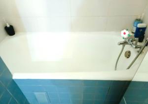 a bathroom with a bath tub with a faucet at Bright & Calm Grand Studio -La Villette Paris- Near Metro in Paris +17 photos