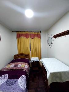 a bedroom with two beds and a window at Residencial 10 de Noviembre in Potosí