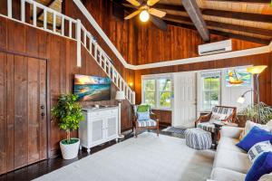 a living room with wooden walls and a ceiling at Beach House on the Sand in St Pete Beach