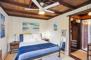 a bedroom with a bed and a ceiling fan at Beach House on the Sand in St Pete Beach
