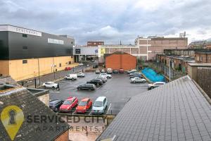 a parking lot with parked cars in a city at SCA - Delightful Studio - VS3 in Wolverhampton