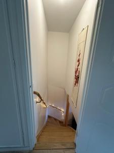 a hallway with a stairwell with a stair railing and a door at Spacious private room in a Vegan household in Gothenburg