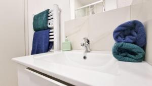 a bathroom with a sink and a mirror at La Résidence Évasion 3 - Original - Gare - Wifi - Relax BNB in Mulhouse +62 photos