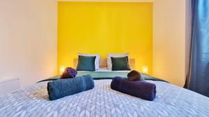 a bed with two people sitting on top of it at La Résidence Évasion 3 - Original - Gare - Wifi - Relax BNB in Mulhouse