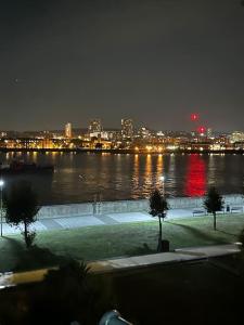 a view of a river at night with a city at Cozy 1 bedroom apartments in East London in London