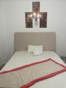 Una cama con cuatro fotos encima. en luxury apartment at Obour, 5th floor no elevator, en El Cairo