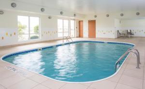 a large indoor pool with blue water in a building at Fairfield Inn & Suites Lafayette in Lafayette