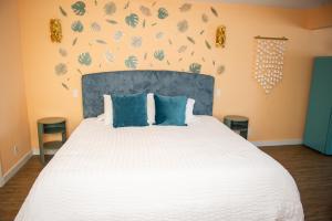 a bedroom with a large white bed with blue pillows at Sunburst Inn- Indian Shores Beach in Clearwater Beach