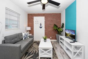 a living room with a couch and a ceiling fan at Cozy 11 & Patio Near The Beach- Unit #3 in Hollywood