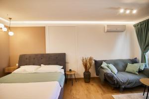 a bedroom with a bed and a couch at ChECk apartment in Focşani