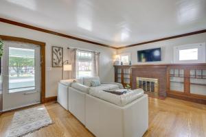 a living room with a white couch and a fireplace at Welcoming Home in Youngstown with Private Backyard! in Youngstown
