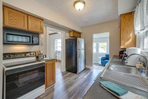 a kitchen with a stainless steel refrigerator and a sink at Welcoming Home in Youngstown with Private Backyard! in Youngstown