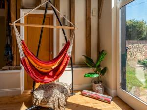 a hammock in a room with a window at Pass the Keys Bradenham Barn in The Chiltern Hills in Bradenham