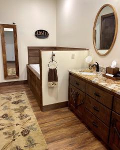 a bathroom with two sinks and a tub and a mirror at The Dogwood Inn in Blue Ridge