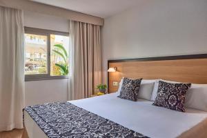 A bed or beds in a room at Zafiro Tropic