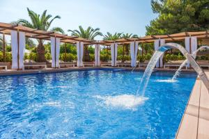 a pool with a water slide in a resort at Zafiro Can Picafort in Can Picafort