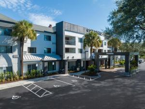 a rendering of the front of a hotel with a parking lot at Courtyard Tampa North / I-75 Fletcher in Tampa