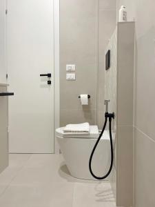 a white bathroom with a toilet and a shower at 7 SKY UDINE in Udine