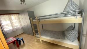 a bedroom with two bunk beds in a room at Casa al Lag - direkt am Laaxersee in Laax