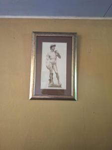 a framed picture of a man on a wall at POSADA VERDE 