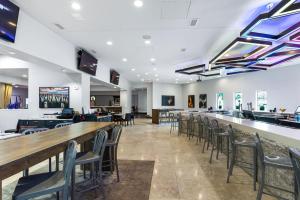 a dining room with chairs and a bar at Harborside Hotel in Oxon Hill