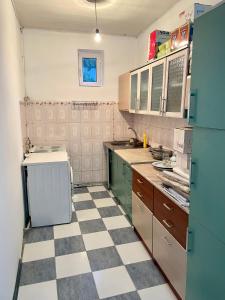 a kitchen with a checkered floor in at Sunny Valley Karakol in Karakol