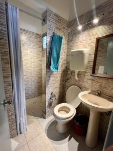 a bathroom with a toilet and a sink at HOTEL MEDITERRANEO in Montevideo