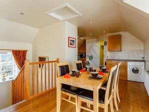 a kitchen and dining room with a table and chairs at Craiglea Barn in Latheron
